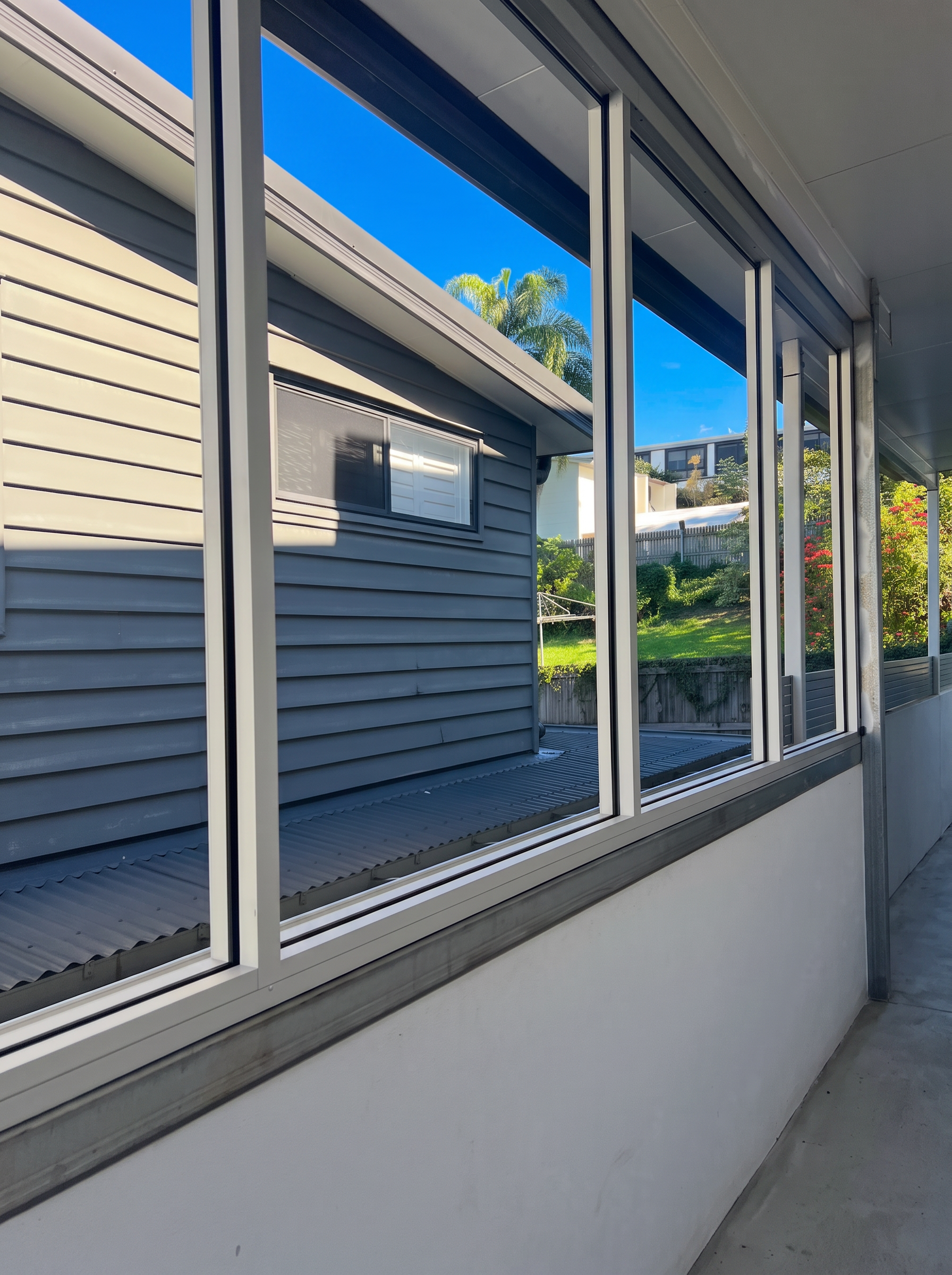Hillside Balcony Enclosure — Slimline sliding window wall · Weather enclosure